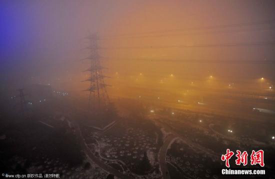 剛告別初雪，京城陷入“霧區(qū)”。2011年12月4日晚，北京阜石路石景山區(qū)楊莊段，被大霧籠罩。李文明 攝 CFP視覺中國
